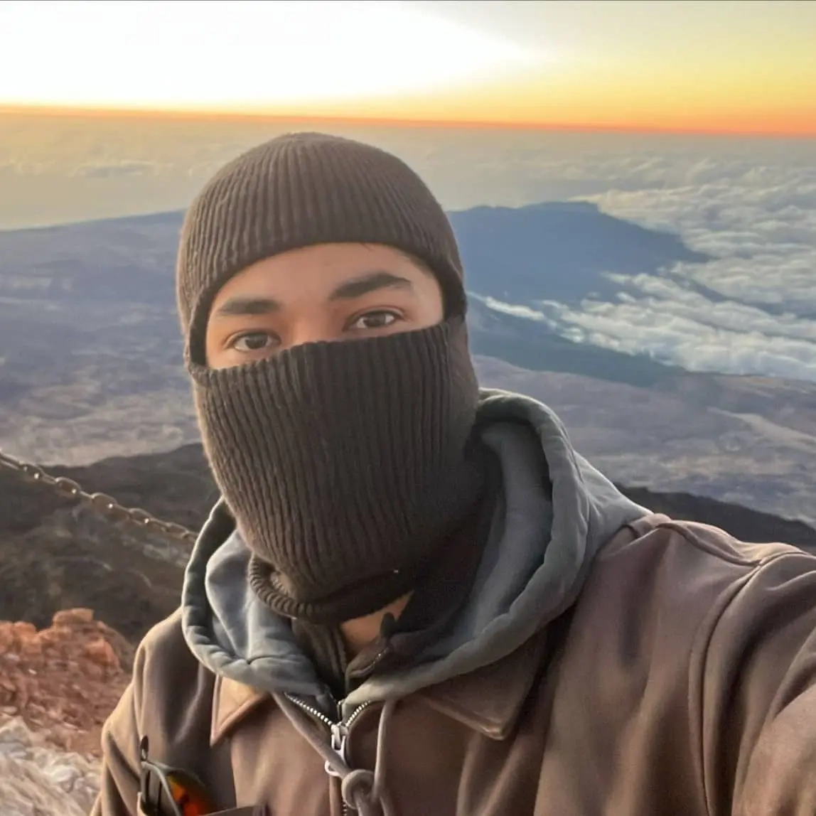 A picture of bryan smiling in Havanna, Cuba with the Gulf of Mexico behind him.