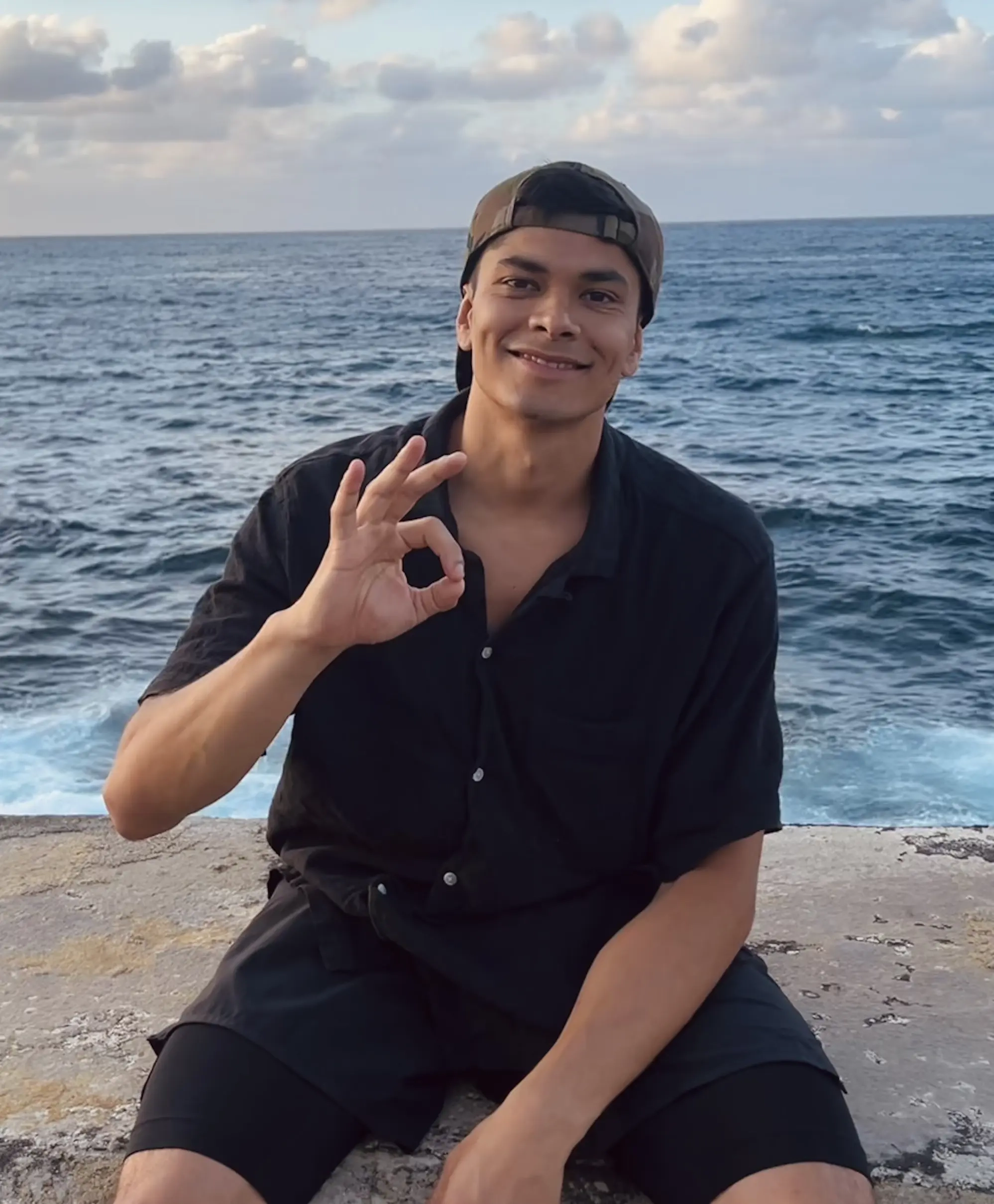 A picture of bryan smiling in Havanna, Cuba with the Gulf of Mexico behind him.